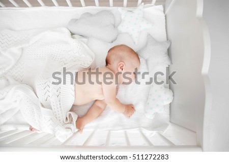 Little baby sleeping in crib , top view Royalty-Free Stock Photo #511272283