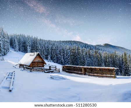 chalets in the mountains at night under the stars. Magic event in frosty day. In anticipation of the holiday. Dramatic scenes. Carpathians, Ukraine, Europe