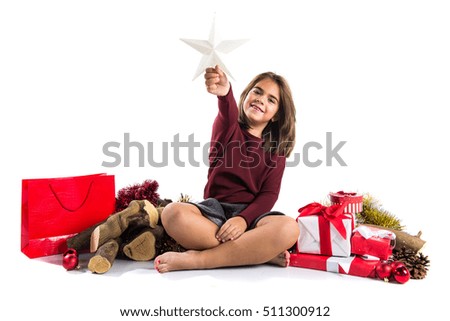 Little girl in christmas holidays holding a star