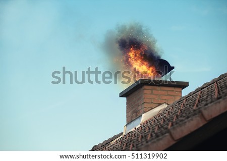 Chimney with fire coming out Royalty-Free Stock Photo #511319902