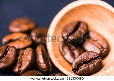 Brown roasted coffee beans, seed with spoon. Espresso dark, aroma, black caffeine drink. Closeup isolated energy mocha, cappuccino ingredient. 