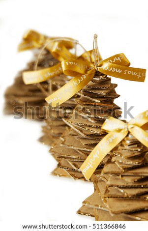 Golden ribbon and cardboard handmade Christmas tree isolated on white background