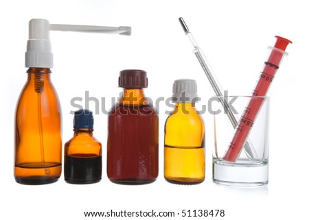 Medical supplies - vial bottles and pills on white background
