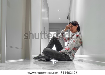 Depressed Woman Sitting on the Floor Alone