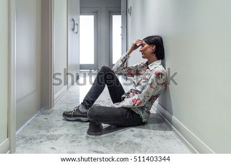 Depressed Woman Sitting on the Floor Alone