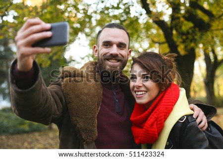 Happy couple making self with phone.