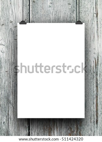 Single blank frame hanged by clips against gray wooden boards background