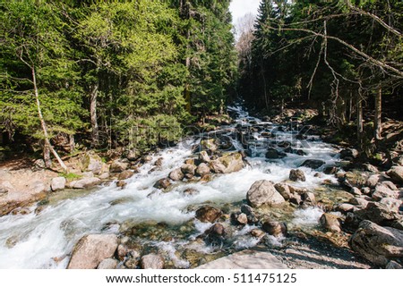 stormy mountain river with rocky bottom horizontal photo