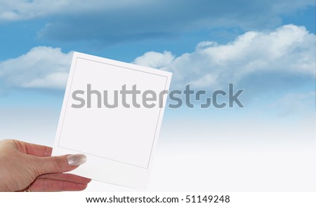 empty card in a hand on the blue sky