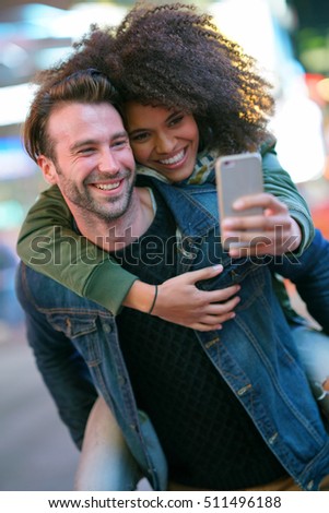 Couple at Times Square taking selfie picture