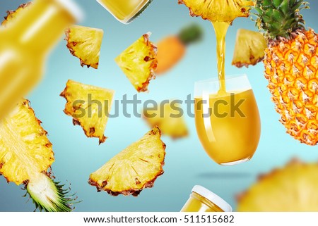 pineapple juice poured in a glass and pineapple fruits flying around Royalty-Free Stock Photo #511515682