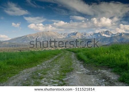 Rural landscape - road, green fields and mountains on the background - The Tatra Mountains, Poland