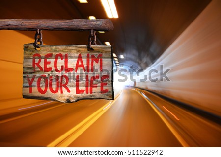 Reclaim your life motivational phrase sign on old wood with blurred background