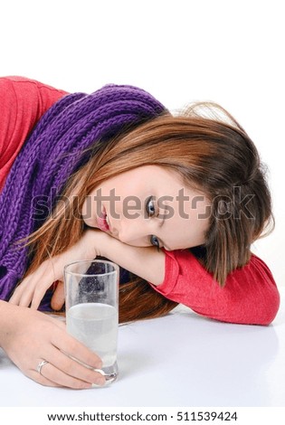 woman taking pills holding a glass of water in office