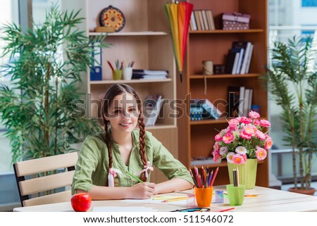 Young girl drawing pictures at home