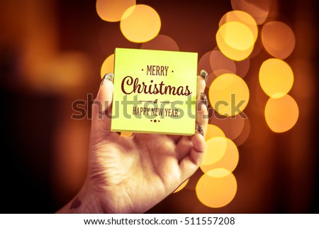 Merry Christmas and Happy New Year on bokeh background, festive defocused lights.
 Royalty-Free Stock Photo #511557208