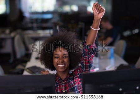 young black woman at her workplace in modern office  relaxing and working on laptop computer