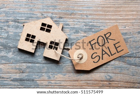 Small house with for sale sign