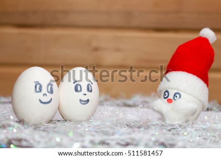 Santa Claus congratulates family with Christmas and the New year. Unusual eggs from the face of the muzzle.A Christmas cartoon.The template cards.