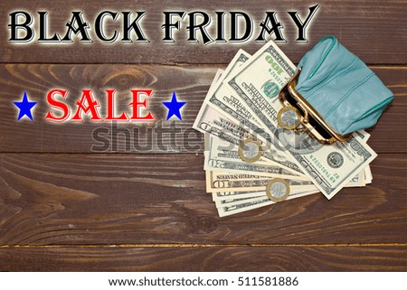 Black Friday sale. The concept of sales and costs - money, purse and text on wooden background, top view. The place to advertise.