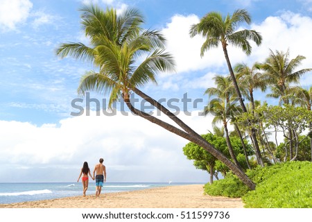 Hawaii beach vacation couple walking - people lifestyle. Kaanapali beach, Maui, Hawaii, USA. Two person, man, woman together relaxing on famous hawaiian beach destination for summer travel holidays. Royalty-Free Stock Photo #511599736
