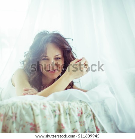 beautiful and gentle young woman lying on bed