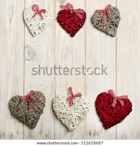 Concept Of Valentine's Day. Wicker hearts on wooden background white.
