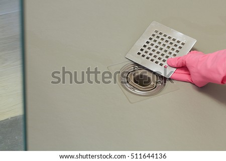 Shower drain box grate on a shower base. Royalty-Free Stock Photo #511644136