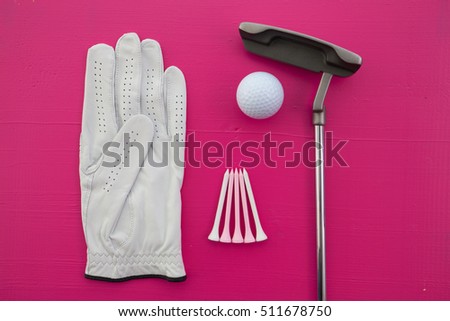 Different golf equipments on the pink  desk - flat lay photography