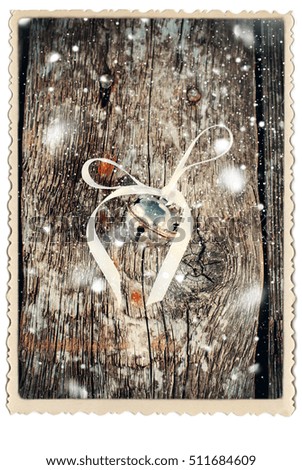 Christmas Card with Jingle Bell on Wooden Table Vintage Toys White Ribbon Drawn Snowfall Vintage Retro Photo Frame Isolated White