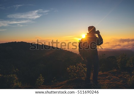 silhouette of photographer taking photo at sunset