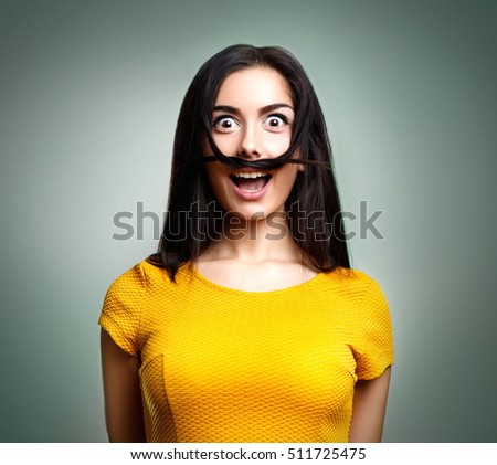 Portrait of funny teenage girl with mustache Royalty-Free Stock Photo #511725475