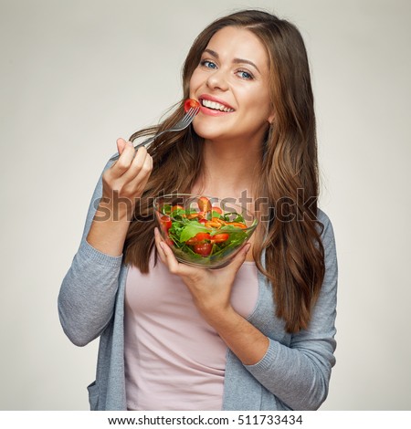 healthy food, healthy life style with young woman eating salad. isolated portrait on white background.