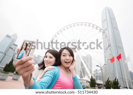 two beauty woman smile happily and selfie in hongkong