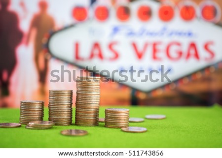 Stack of US. dallor coins with Las vegas sign background