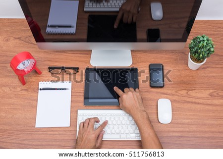 Office Monitor computer PC, keyboard, Mobile Phone, magic mouse and tablet on wooden desk