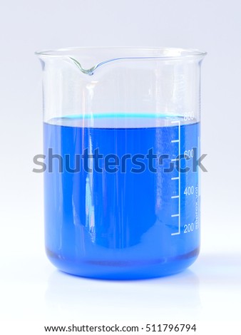 Glass chemical beaker with blue chemicals dissolved in water isolated on white background