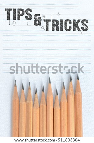 Top view of wooden pencils with word Tips and tricks on paper with copy space