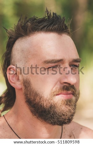 Young handsome bearded man with stylish haircut