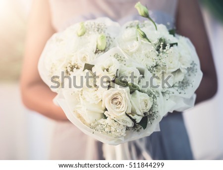 Bride holding the bouquet flower in wedding ceremony day. vintage tone