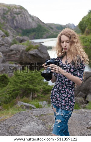 beautiful girl photographer on the background of beautiful nature