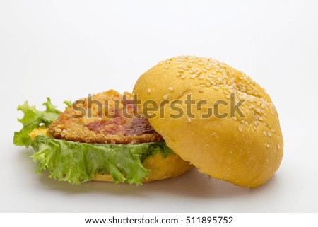 Hamburger with cheese, bacon, pickles, tomato, onions and lettuce.