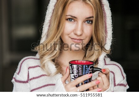 Beautiful young woman drinking tea Beautiful girl celebrates Christmas with a cup of cocoa
