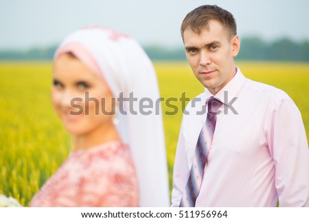 Beautiful couple just married on the field of wheat. Muslim marriage.