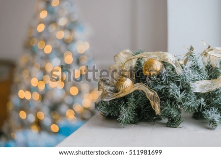 Gold and blue Christmas background of de-focused lights with decorated tree