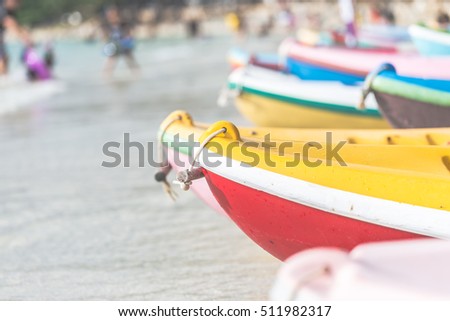 Multicolor rowboat or sea kayaks on beach with copy space. in holiday time.