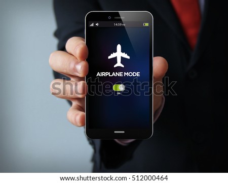 new technologies concept: businessman hand holding a 3d generated touch phone with airplane mode on the screen. Screen graphics are made up.
 Royalty-Free Stock Photo #512000464
