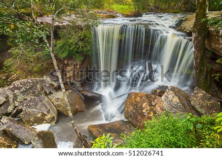 Waterfall in thai national park. In the deep forest on mountain.