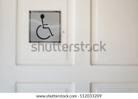 close up of toilet door with disable sign