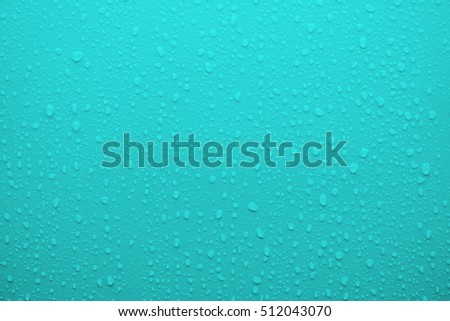 Condensed water drop on cyan blue surface as background